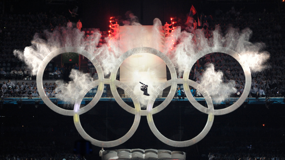 12.02.2010, Whistler, Canada (CAN): Snowboarder jumps through Olympic Rings at the beginning of the ceremony A snowboarder jumps through the olympic rings - XXI Olympic Winter Games Vancouver 2010, opening ceremony, Vancouver (CAN). www.nordicfocus.com. © NordicFocus. Every downloaded picture is fee-liable.