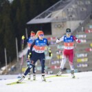 Jenny Nowak (GER) und Yuna Kasai (JPN) (l-r)laufen mit aufgemaltem Bart vor den Olympischen Ringen.